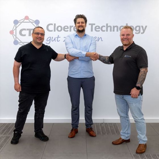 Metal Spark en Cloeren Technology schudden elkaar de hand op de nieuwe samenwerking, voor het logo van Cloeren